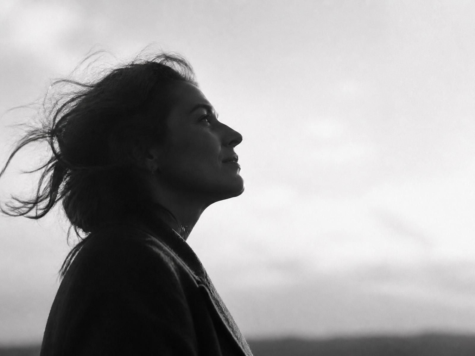 A woman looking upward toward open sky